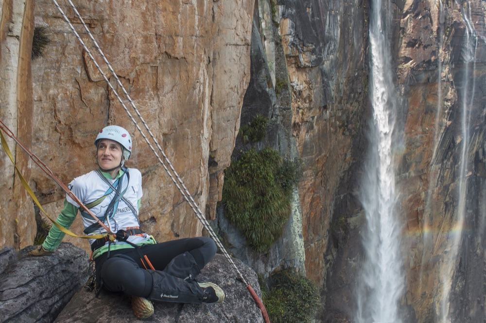 A climber rappelling down a tepui wall