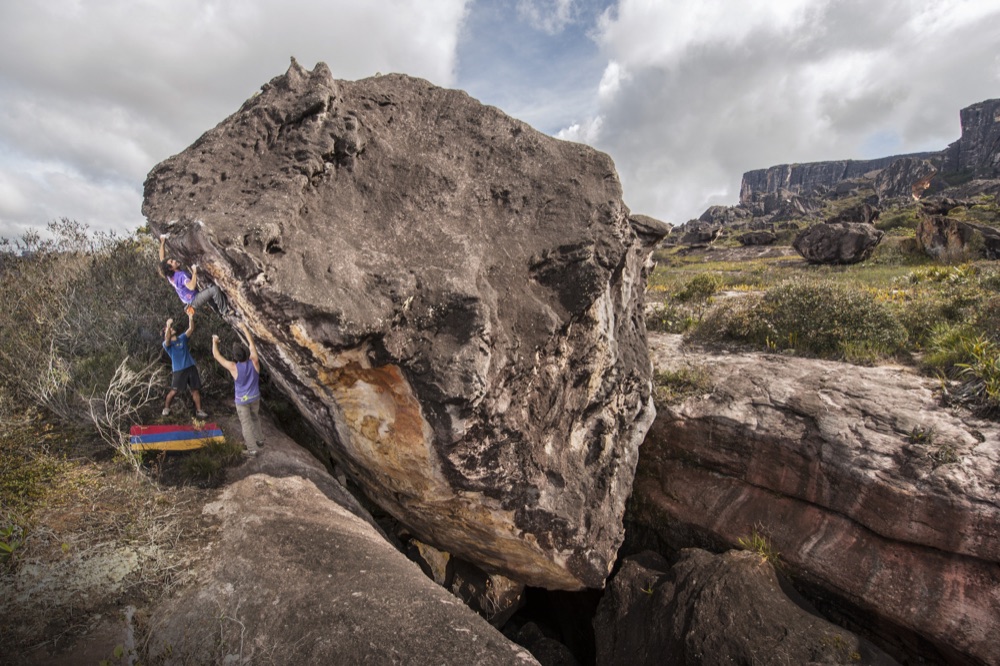 A climber on a boulder on the Auyán-tepui summit